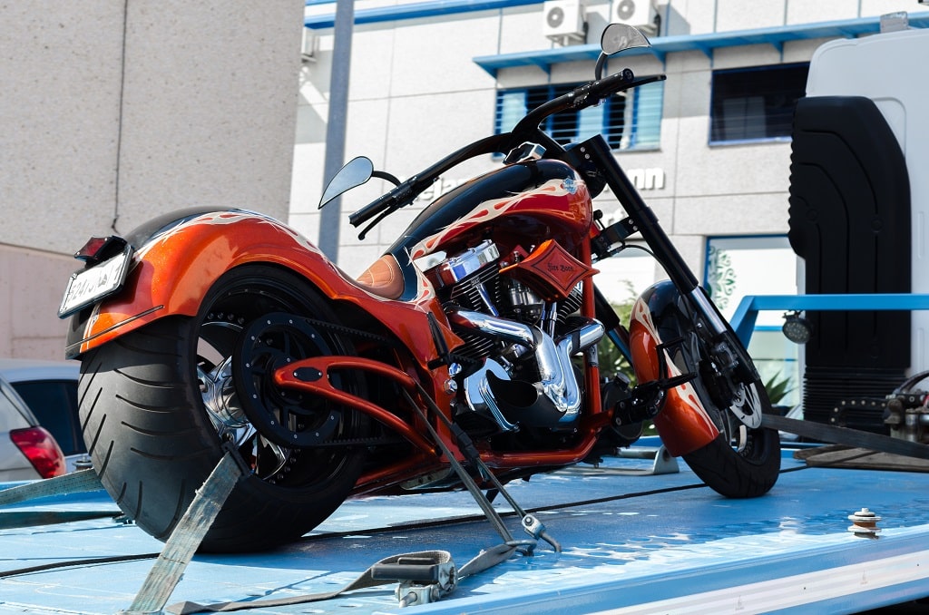 Motorcycle being towed by a specialized vehicle